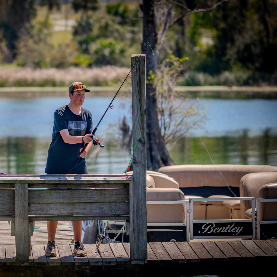 Photo of a young boy fishing off the docks at Florida Caverns RV Resort